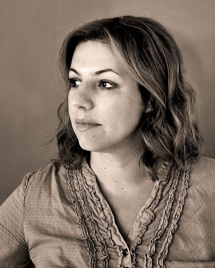 A portrait of Jelena Dunato, a light-haired white woman in a historical-looking blouse.